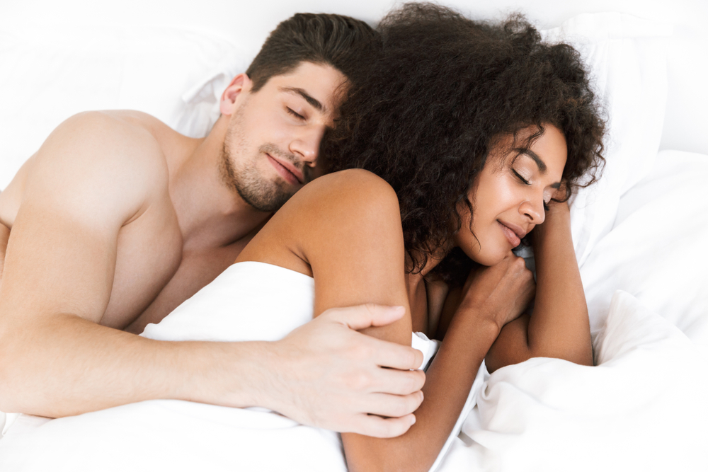 happy young couple sleeping naked