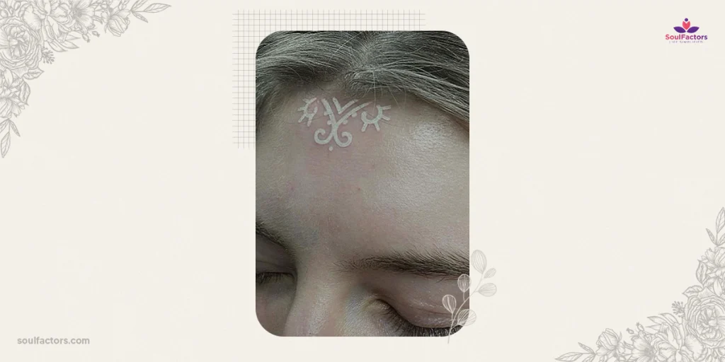 white forehead tattoo